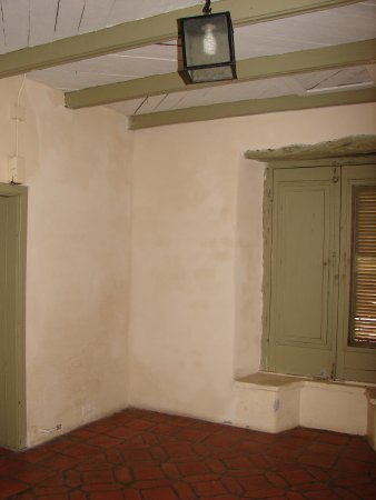 A fresh coat of plaster protects the repaired adobe bricks.