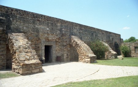 Restored granary with flying buttresses (arches that brace the walls).