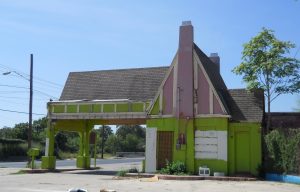 Side view of vacant Tudor-Revival style gas station at 901 Nogalitos.