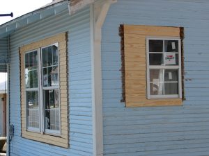 A house with original wood windows loses character with with vinyl replacements.