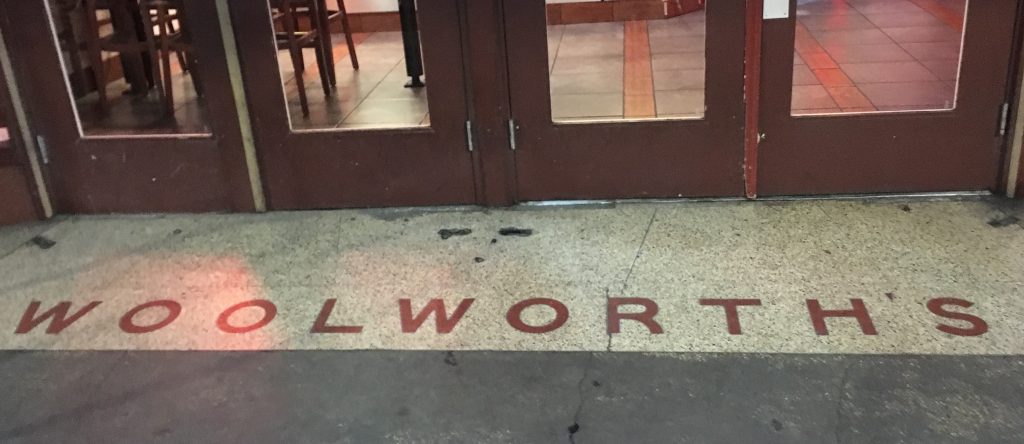 Woolworth's name spelled out on the floor in front of the Houston Street entrance