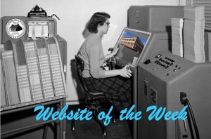 Woman sitting at 1950s computer