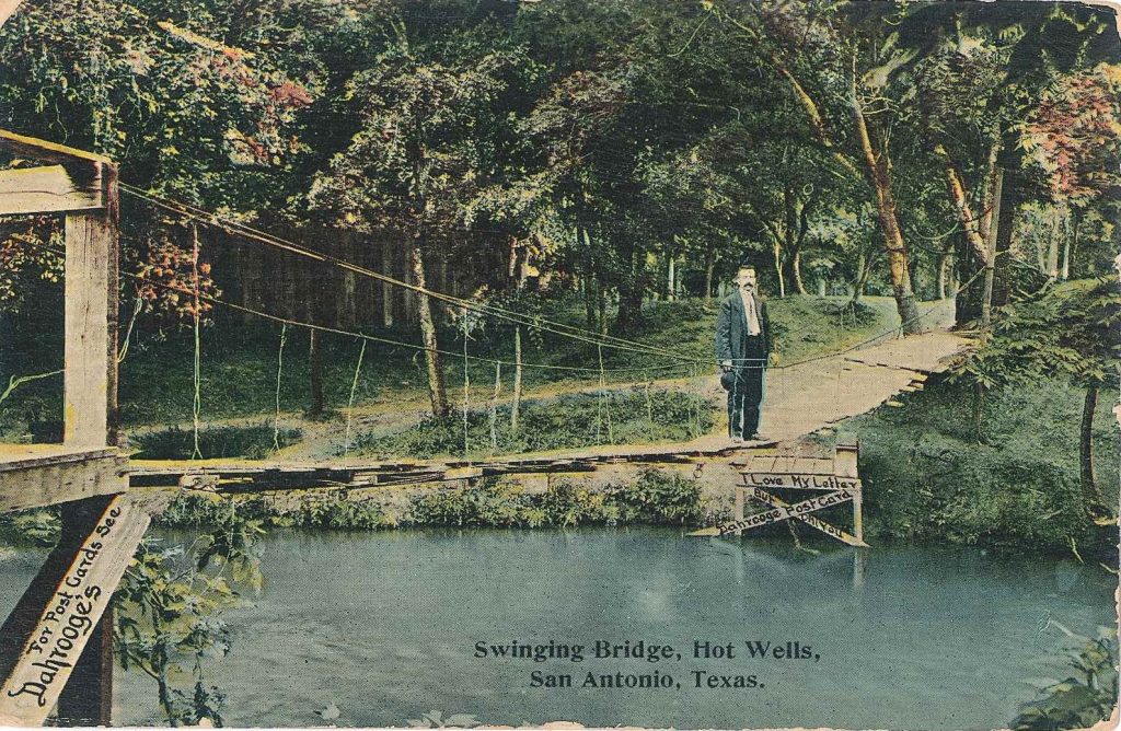 Postcard of a wooden bridge over the San Antonio Rivar at Hot Wells.