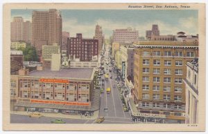 Color postcard looking west on Houston Street from Alamo Plaza. Woolworth Building on left.