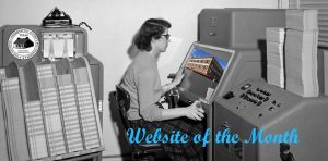 Black and white photo of a woman looking at the screen of a punch card computer
