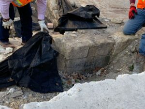Workers examine the cornerstone of St. James AME Church near San Pedro Creek.